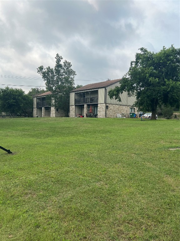 151-201 Springlake Drive Dripping Springs, TX 78620 - Photo 2 of 12 a front view of house with yard and trees