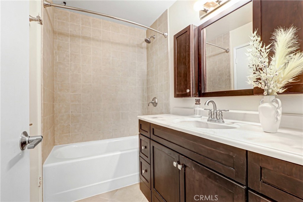 9849 Allesandro Court Rancho Cucamonga, CA 91730 - Photo 16 of 20 a bathroom with a granite countertop sink and a bathtub