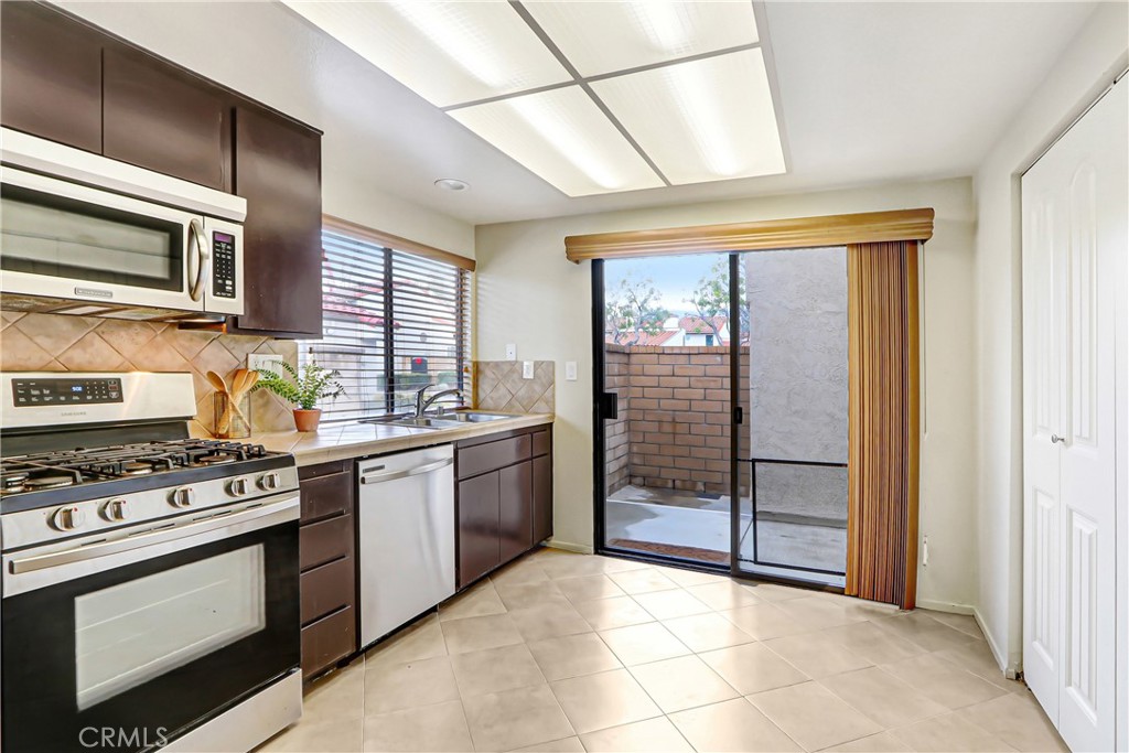 9849 Allesandro Court Rancho Cucamonga, CA 91730 - Photo 9 of 20 a kitchen with stainless steel appliances granite countertop a stove and a microwave