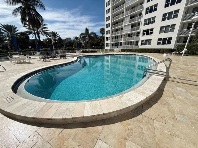 a view of a swimming pool with outdoor seating