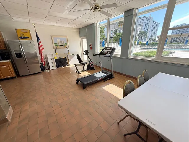a living room with furniture gym equipment and a large window