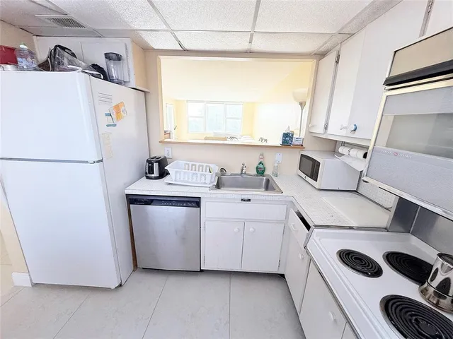 a room with a refrigerator and a sink