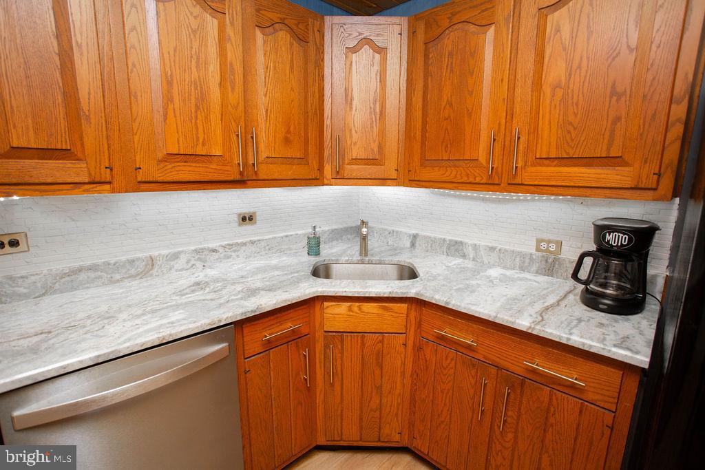 622 Spruce Avenue Pitman, NJ 08071 - Photo 14 of 47 a kitchen with granite countertop cabinets stainless steel appliances a sink and dishwasher