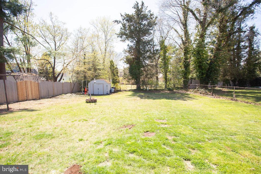 622 Spruce Avenue Pitman, NJ 08071 - Photo 41 of 47 a swimming pool that has lawn chairs and wooden fence
