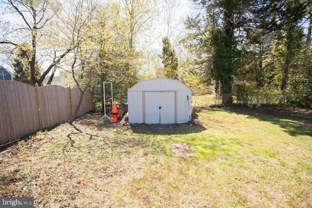 622 Spruce Avenue Pitman, NJ 08071 - Photo 46 of 47 a backyard of a house with a large tree and wooden fence