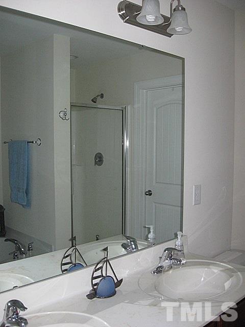 7641 Weathered Oak Way Raleigh, NC 27616 - Photo 12 of 20 a bathroom with a sink and a mirror