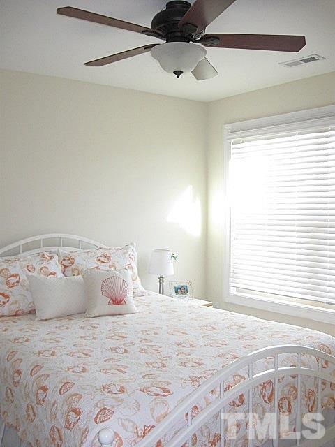 7641 Weathered Oak Way Raleigh, NC 27616 - Photo 13 of 20 a large bed sitting in a bedroom next to a window and a chandelier