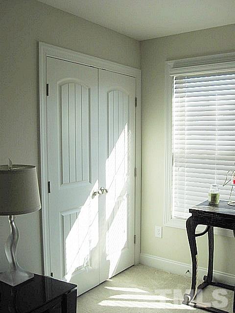 7641 Weathered Oak Way Raleigh, NC 27616 - Photo 16 of 20 a view of a hallway with wooden floor and windows
