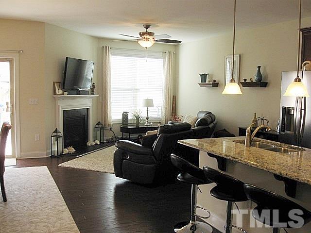 7641 Weathered Oak Way Raleigh, NC 27616 - Photo 4 of 20 a living room with furniture a flat screen tv and kitchen view