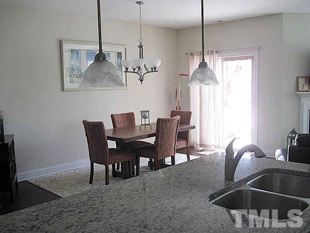 7641 Weathered Oak Way Raleigh, NC 27616 - Photo 7 of 20 a dining room with furniture and window