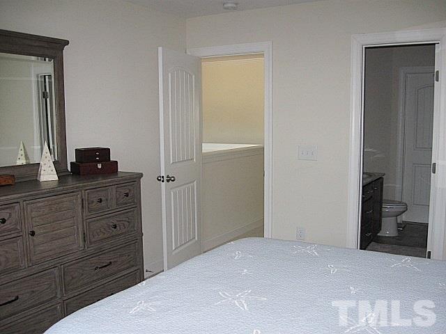7641 Weathered Oak Way Raleigh, NC 27616 - Photo 10 of 20 a bedroom with a bed and a dresser
