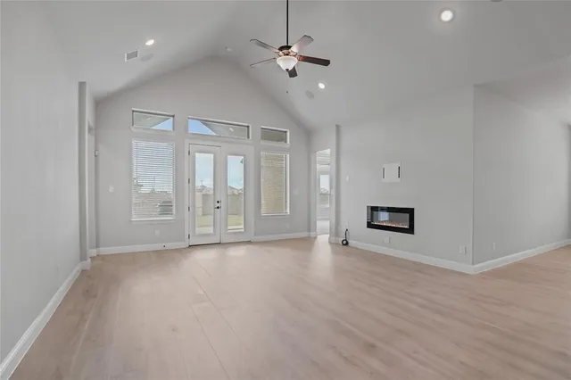 a view of kitchen with kitchen island a sink wooden floor and a refrigerator