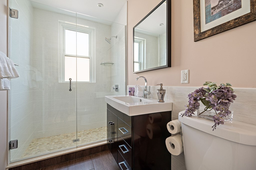 23 Claflin Road, Unit 1 Brookline, MA 02445 - Photo 14 of 41 a bathroom with a sink mirror and vanity