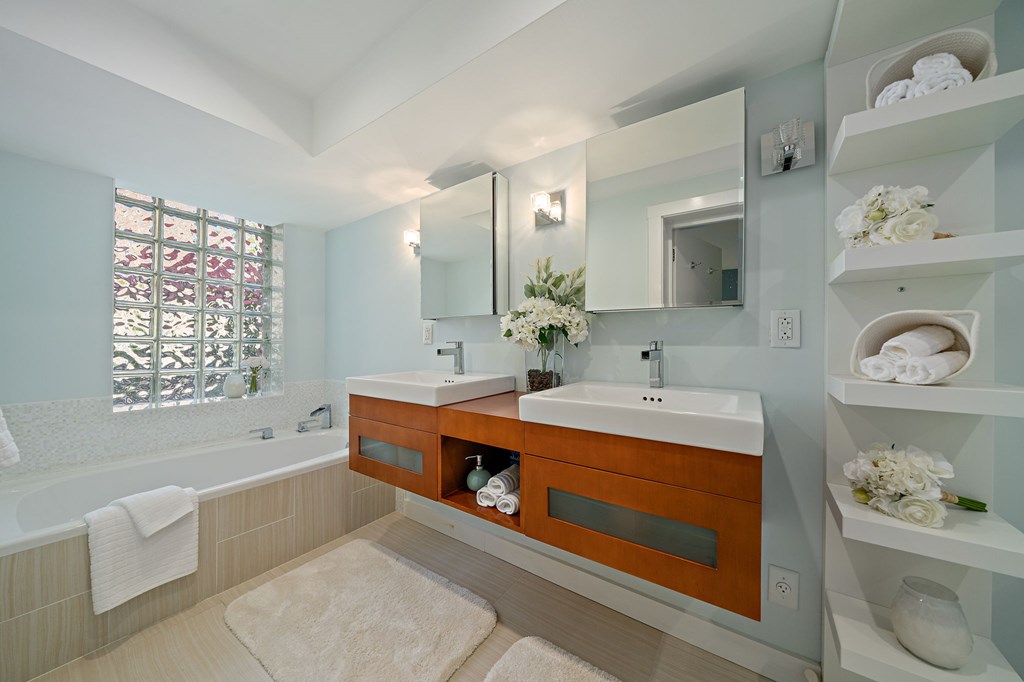 23 Claflin Road, Unit 1 Brookline, MA 02445 - Photo 23 of 41 a spacious bathroom with double vanity sinks a bathtub and a shower