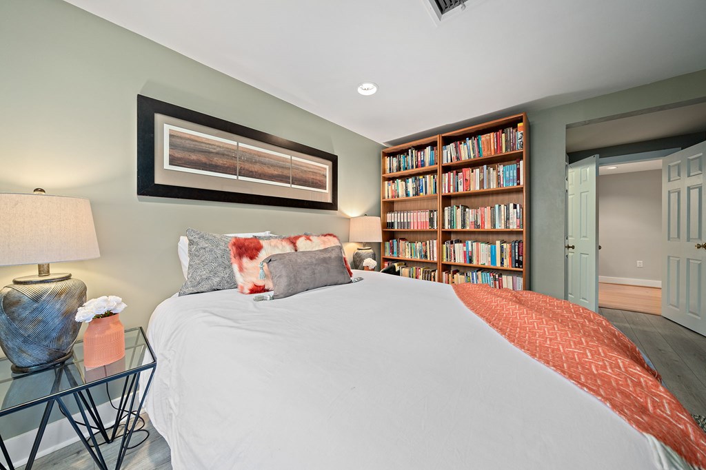 23 Claflin Road, Unit 1 Brookline, MA 02445 - Photo 27 of 41 a bedroom with a bed and a book shelf