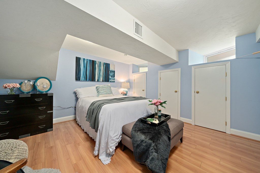 23 Claflin Road, Unit 1 Brookline, MA 02445 - Photo 30 of 41 a bedroom with a bed and wooden floor