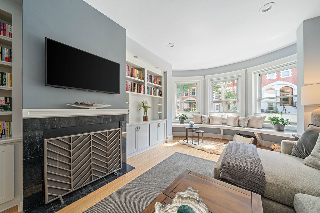 23 Claflin Road, Unit 1 Brookline, MA 02445 - Photo 4 of 41 a living room with furniture a flat screen tv and a fireplace