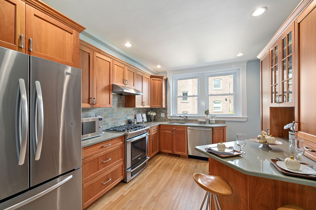 23 Claflin Road, Unit 1 Brookline, MA 02445 - Photo 10 of 41 a kitchen with stainless steel appliances granite countertop a stove refrigerator sink and cabinets