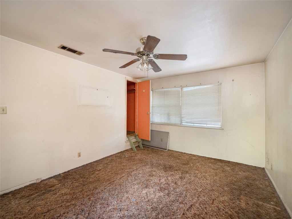 401 Ramble Lane Austin, TX 78745 - Photo 15 of 32 an empty room with a window and a ceiling fan