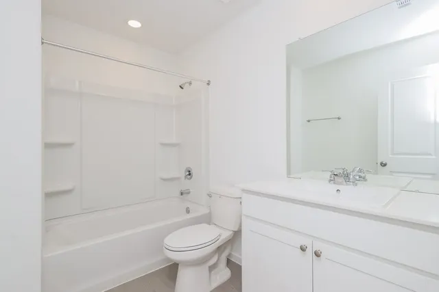 a bathroom with a sink mirror toilet and bathtub