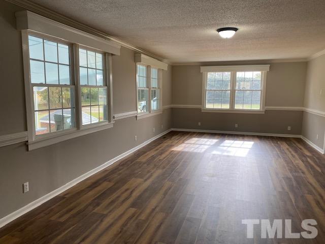 164 Jernigan Road Dunn, NC 28334 - Photo 6 of 30 a view of empty room with wooden floor and fan