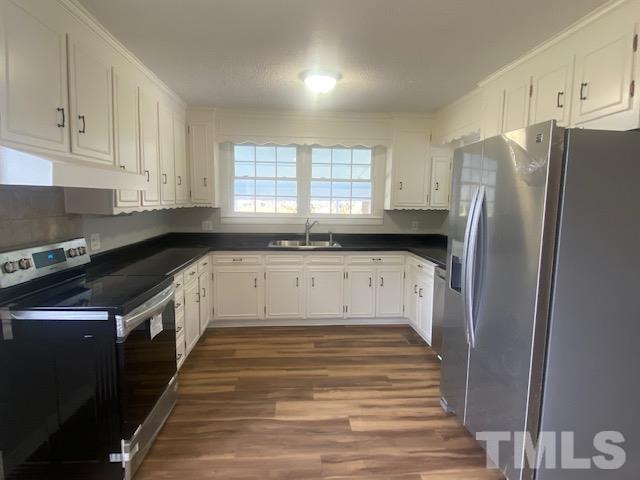 164 Jernigan Road Dunn, NC 28334 - Photo 7 of 30 a kitchen with granite countertop a refrigerator and a sink