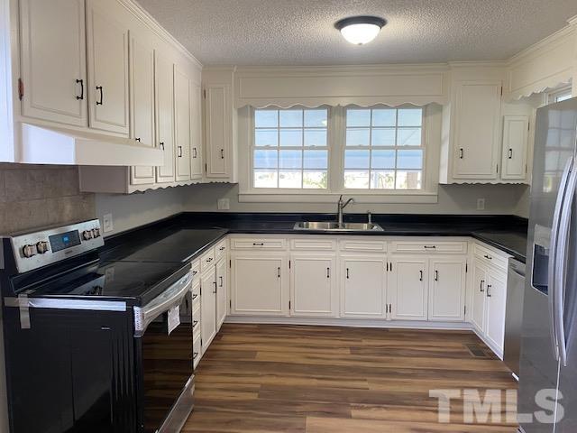 164 Jernigan Road Dunn, NC 28334 - Photo 8 of 30 a kitchen with granite countertop white cabinets and black appliances