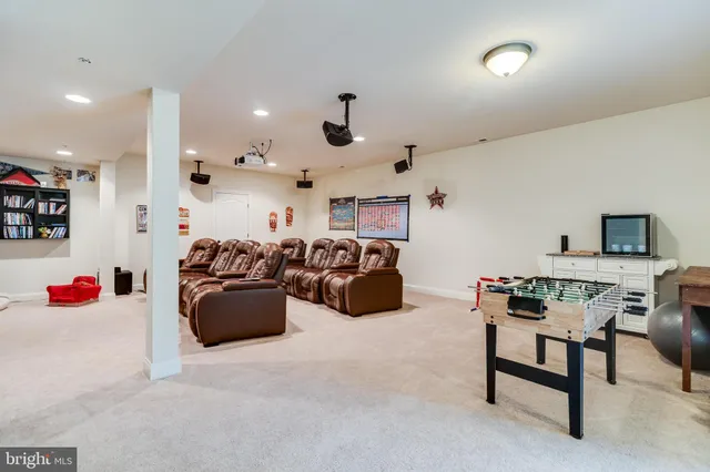a living room with furniture and a ceiling fan