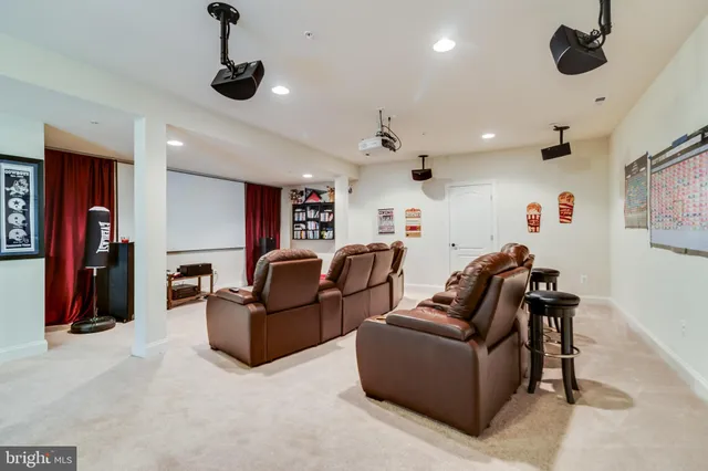 a living room with furniture a ceiling fan and a rug