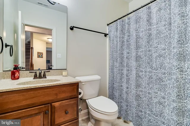 a bedroom with a bed dresser and a window