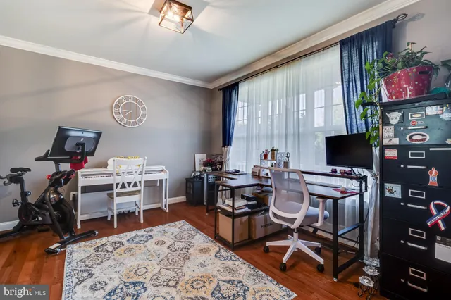 a view of a livingroom with workspace and a window