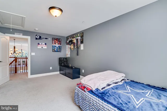 a view of a hallway with a livingroom and chandelier