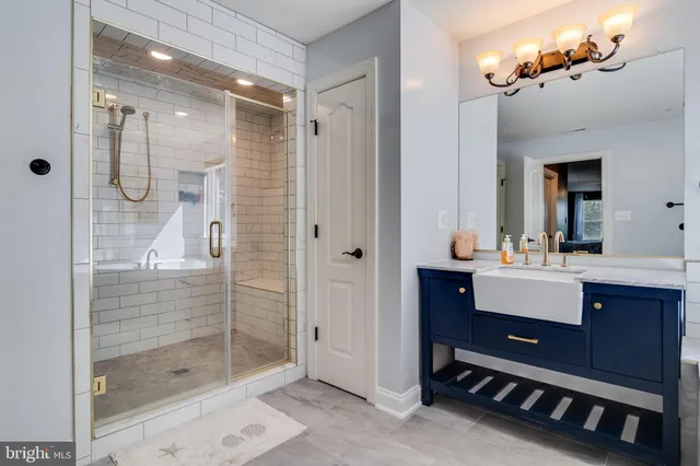 a spacious bedroom with a large bed and a chandelier