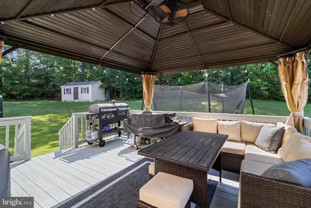 a backyard of a house with plants and large trees