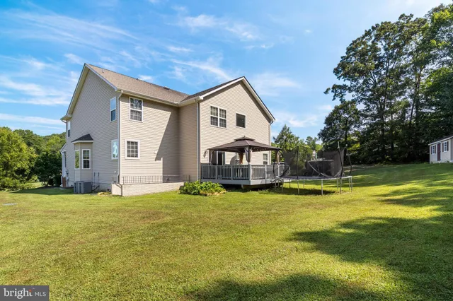 a front view of a house with a yard table and chairs