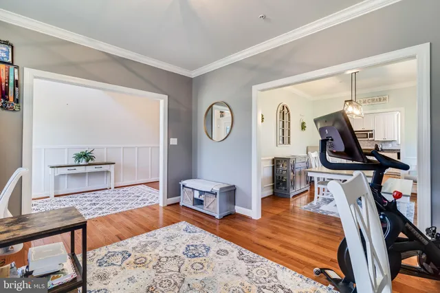 a living room with furniture a rug and a wooden floor