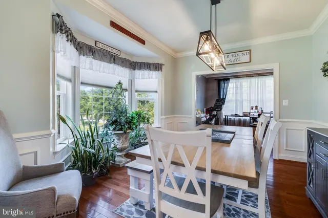 a kitchen with kitchen island granite countertop a stove a sink and a microwave