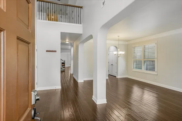 a view of hallway with wooden floor and stairs