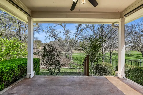 a view of a yard with wooden fence
