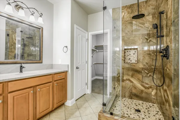 a bathroom with a shower and a sink