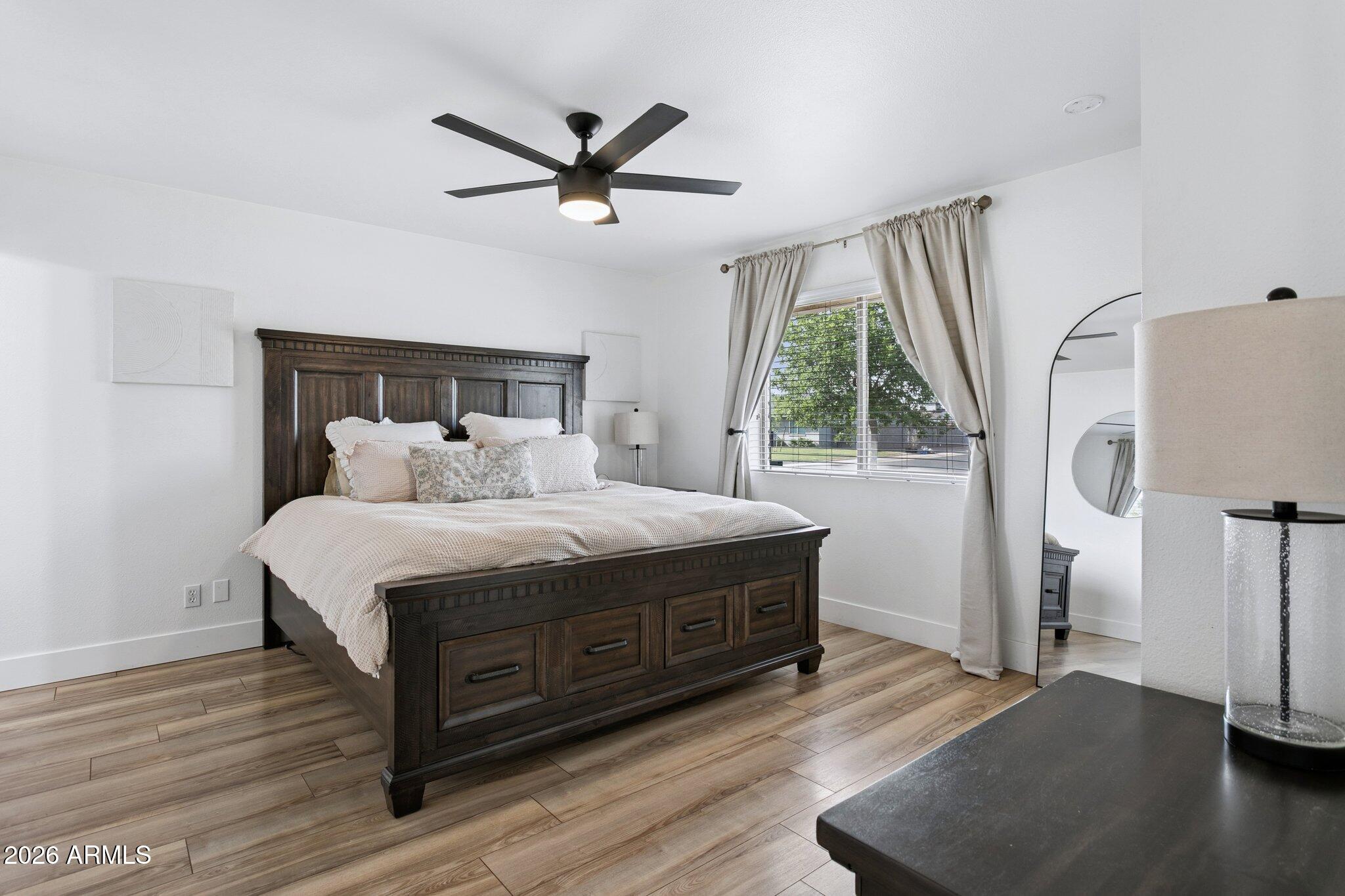 1715 West Orchid Lane Phoenix, AZ 85021 - Photo 24 of 57 a bedroom with a bed and a large window