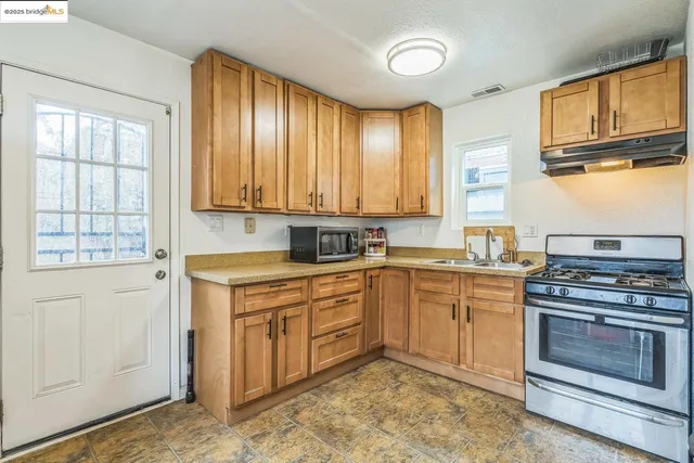 a kitchen with cabinets appliances and a window