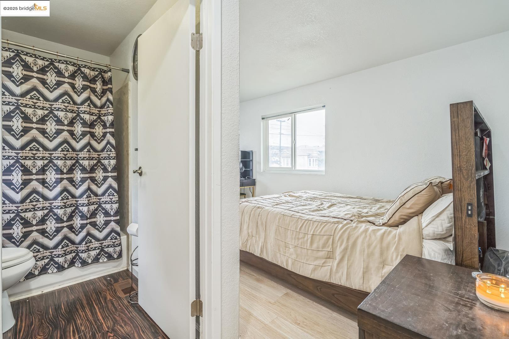 874 Pine Street Oakland, CA 94607 - Photo 15 of 32 a bedroom with a bed and a window