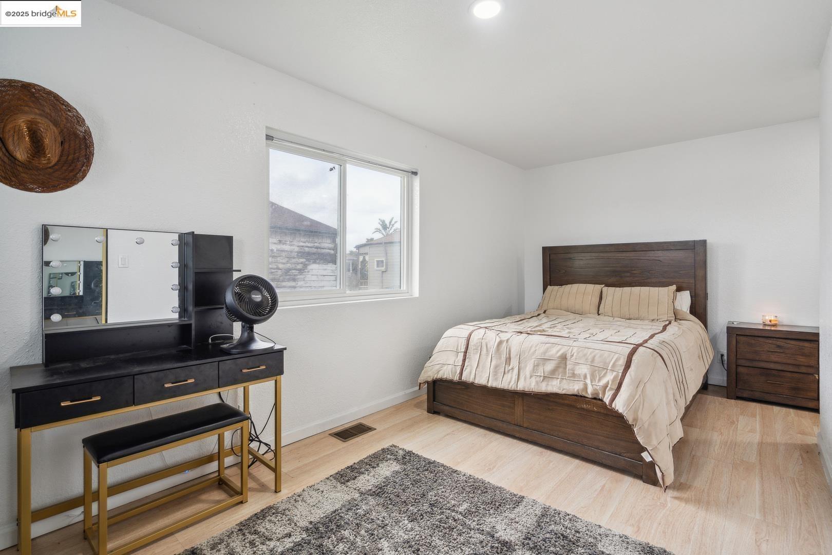 874 Pine Street Oakland, CA 94607 - Photo 16 of 32 a bedroom with a bed and a window