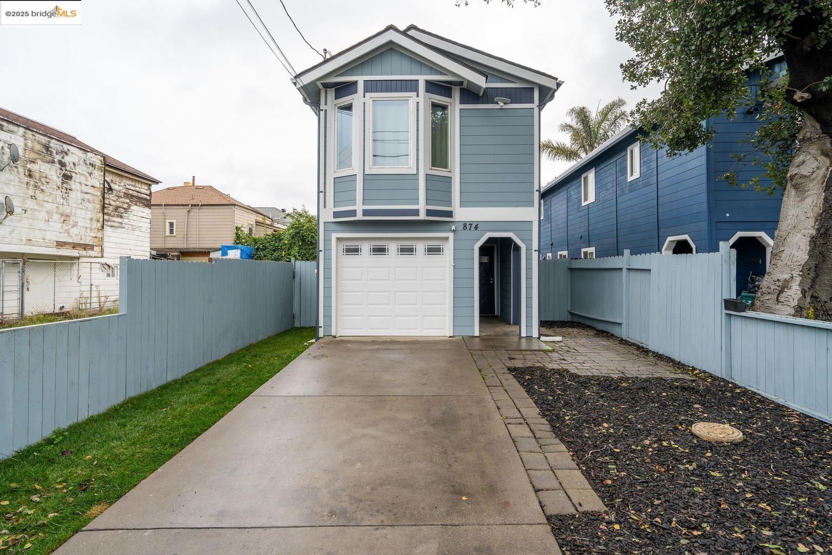 874 Pine Street Oakland, CA 94607 - Photo 2 of 32 a front view of a house with a yard