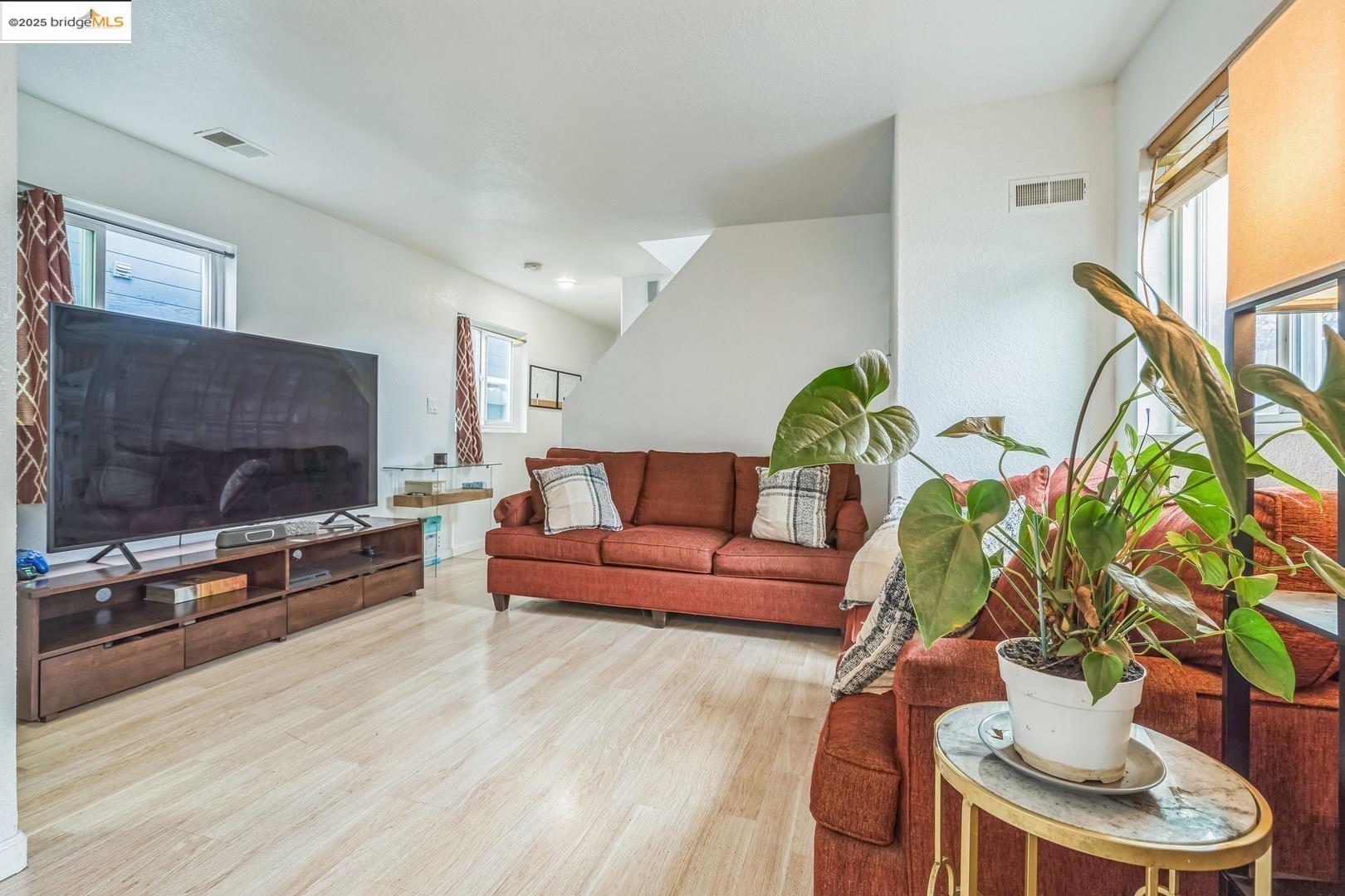 874 Pine Street Oakland, CA 94607 - Photo 5 of 32 a living room with furniture and a flat screen tv