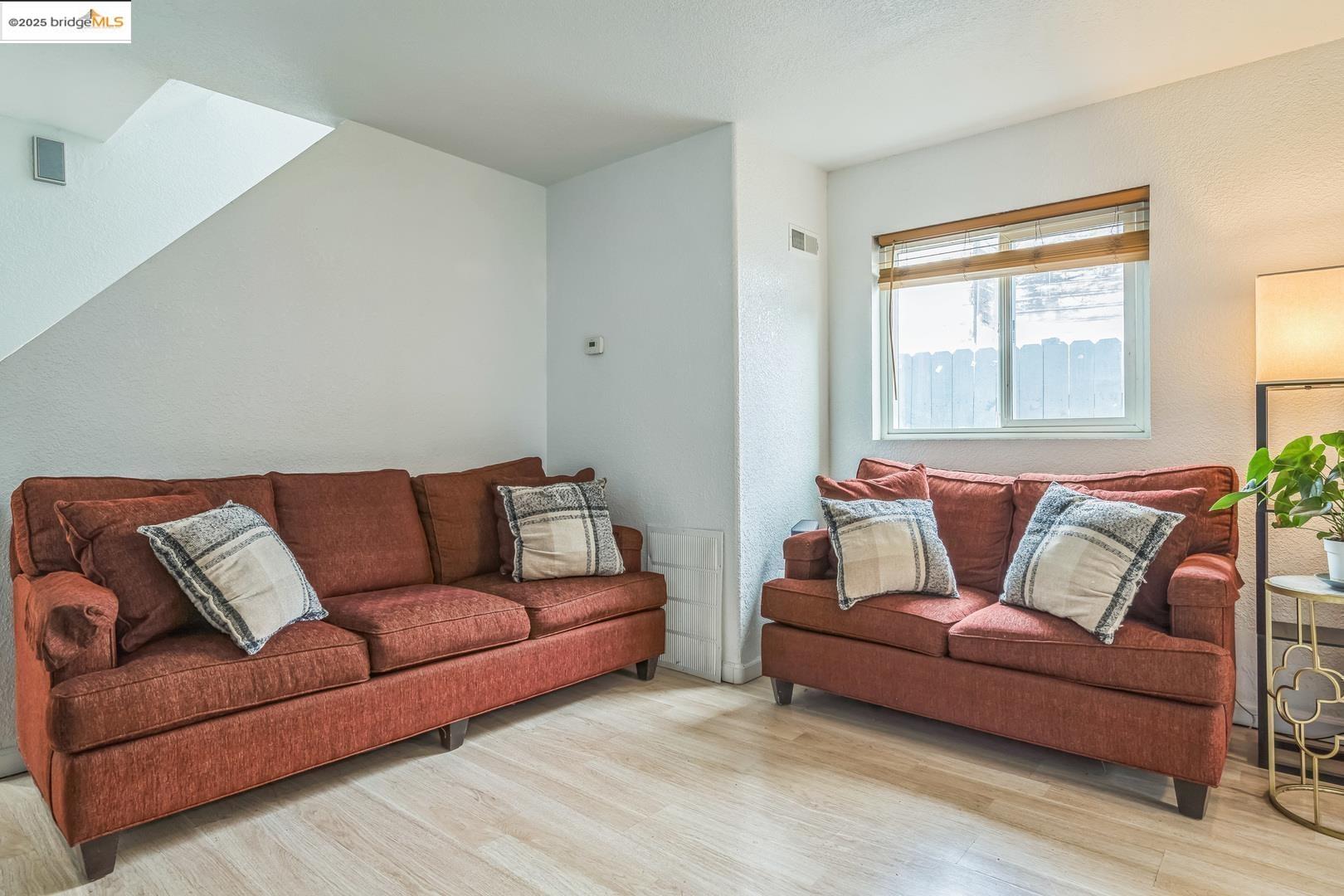 874 Pine Street Oakland, CA 94607 - Photo 7 of 32 a living room with a couch and a window