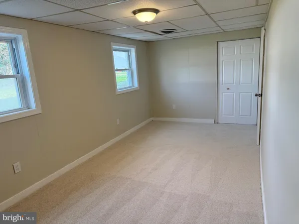 an empty room with windows and closet
