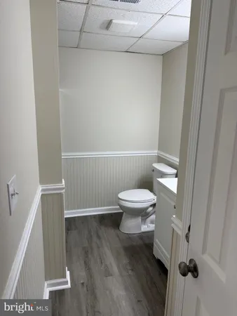 a white toilet sitting next to a sink