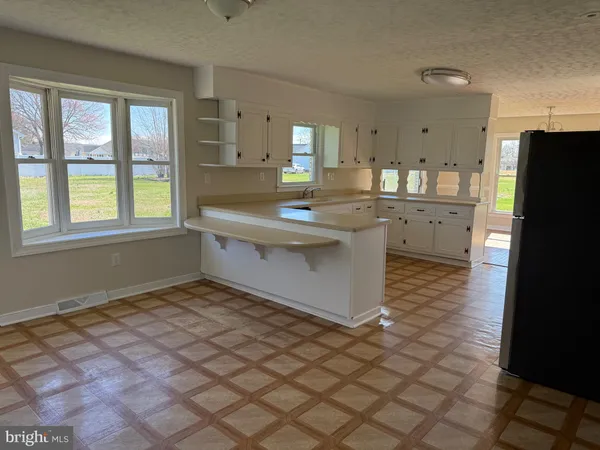 a kitchen with stainless steel appliances a sink stove and cabinets
